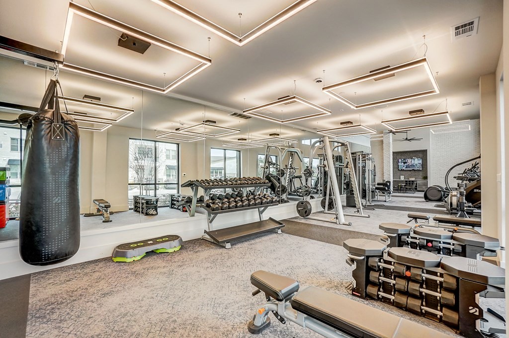 a gym with weights and a punching bag on the wall at Aurora Watson Branch, Texas, 76063