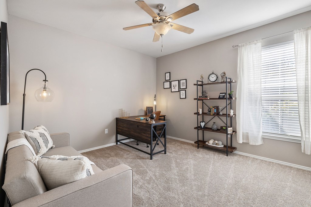 a living room with a couch and a ceiling fan at Sonterra Apartment Homes, Texas