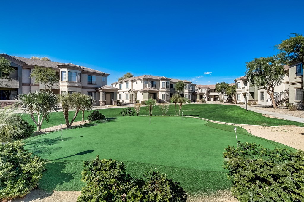a putting green in the middle of an apartment complex  at Adiamo Palm Valley, Goodyear, AZ