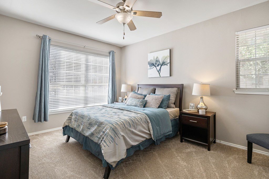 a bedroom with a bed and a ceiling fan at Sonterra Apartment Homes, Austin