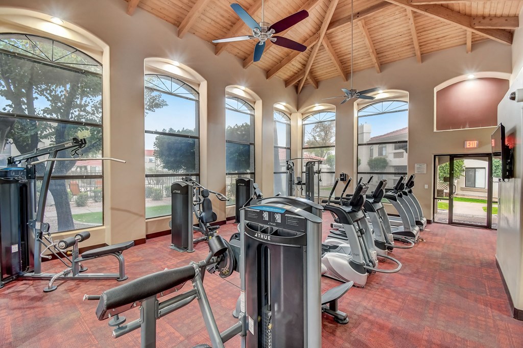 a gym with cardio machines and a ceiling fan  at San Montego Apartments, Arizona, 85206