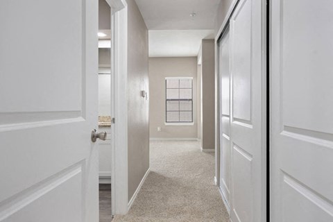 Hallway with beige carpet and white doors at Waters Edge Homes Apartments, Georgetown