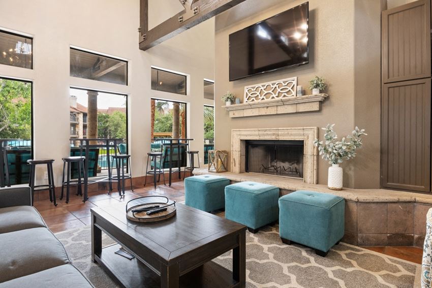 Waters Edge Apartments in Georgetown, TX a living room with a fireplace and a flat screen tv above it - Photo Gallery