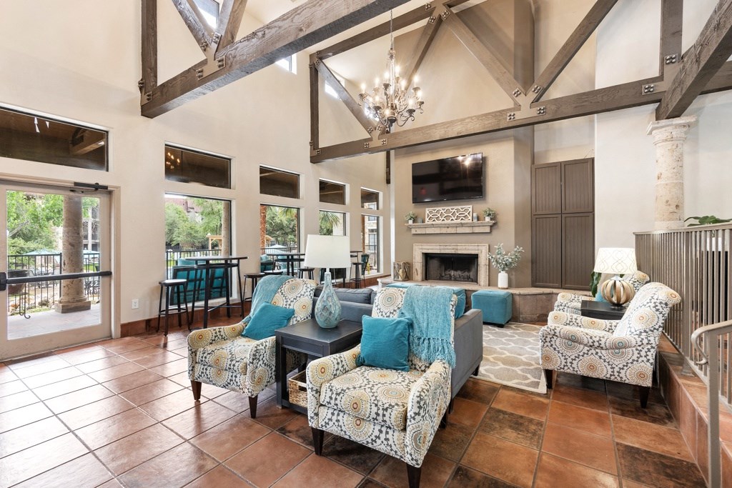 a living room filled with furniture and a large window at Waters Edge Apartment Homes, Georgetown, 78626