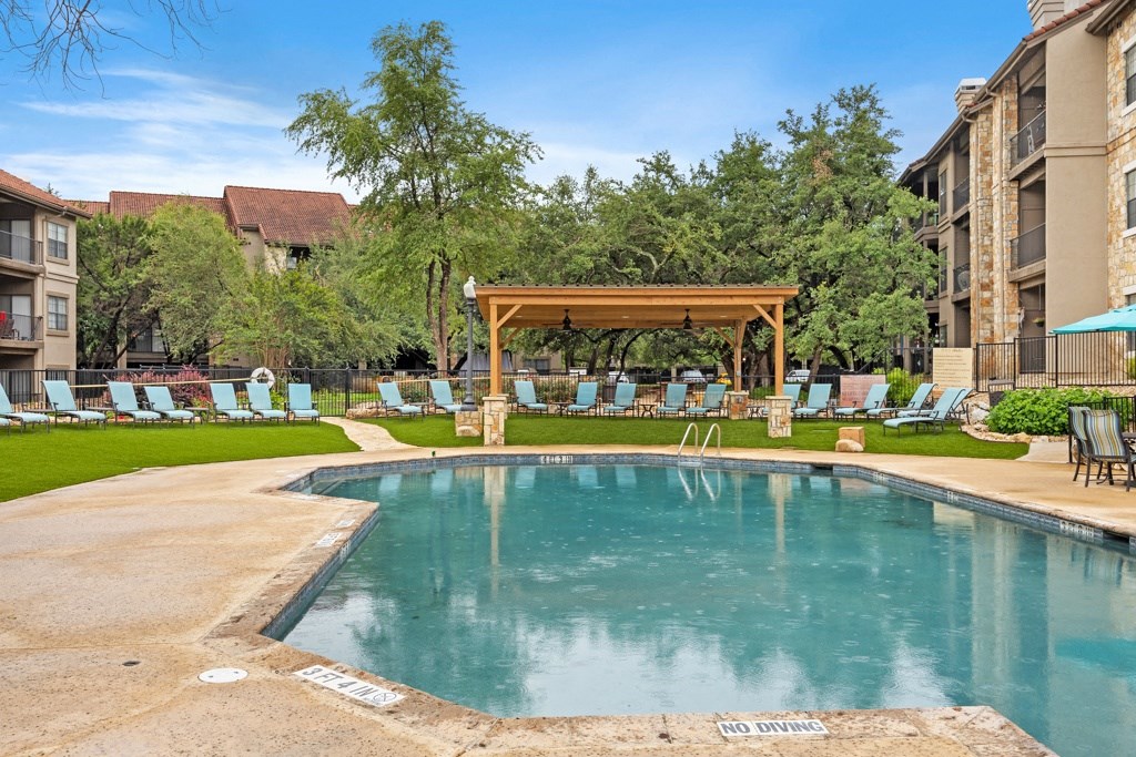 a resort style pool with chaise lounge chairs and a gazebo at Waters Edge Apartment Homes, Georgetown
