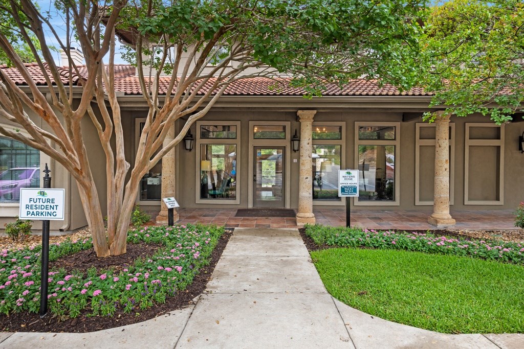 a building with a tree in front of it at Waters Edge Apartment Homes, Texas