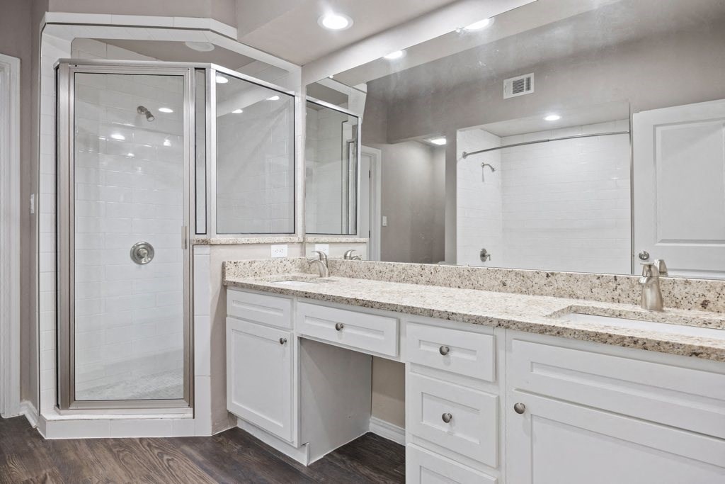 a bathroom with a sink and a shower at Waters Edge Apartment Homes, Texas