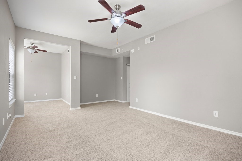 a large empty room with a ceiling fan at Waters Edge Apartment Homes, Georgetown, TX