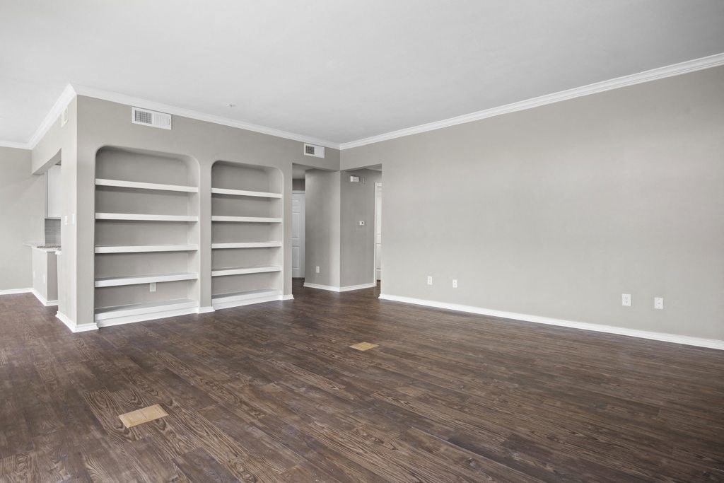 an empty room with hardwood floors and grey walls at Waters Edge Apartment Homes, Georgetown, 78626
