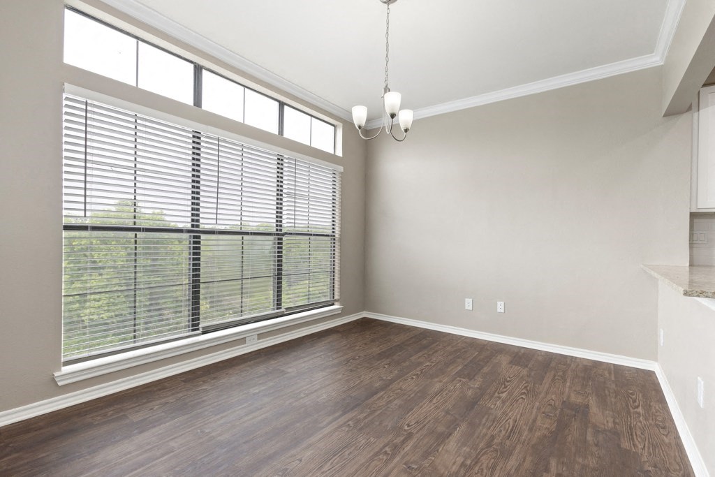 an empty living room with a large window at Waters Edge Apartment Homes, Georgetown, Texas