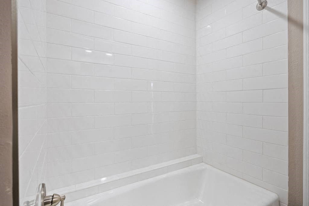a bathroom with a bathtub and a shower at Waters Edge Apartment Homes, Georgetown