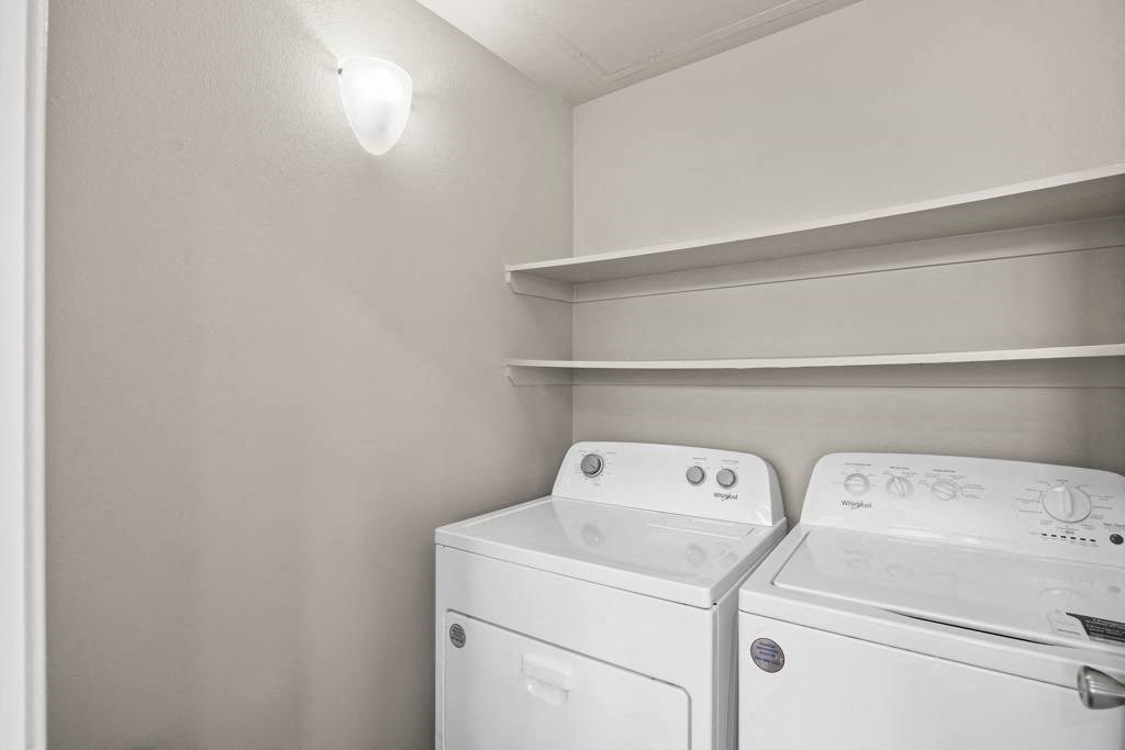 a white washer and dryer in a room at Waters Edge Apartment Homes, Georgetown, TX