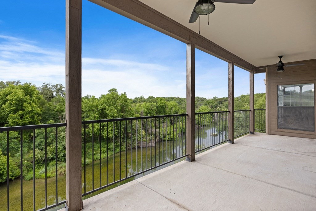 a large balcony with a view of a body of water at Waters Edge Apartment Homes, Georgetown, TX
