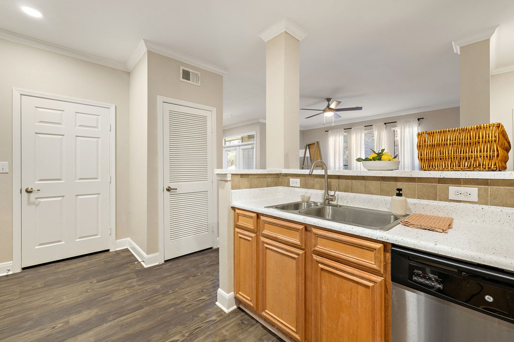 a kitchen with a sink and a door to a living room at The Verandah, Austin, 78726
