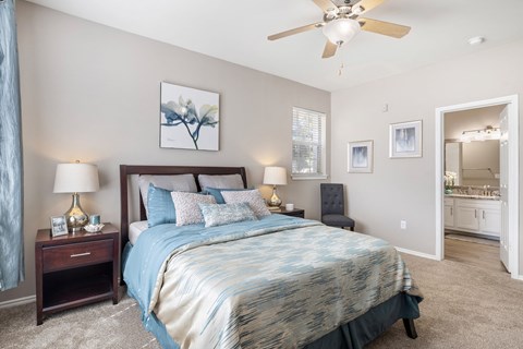 Master bedroom with ensuite bathroom and vaulted ceiling at Sonterra Apartments Homes, Austin, TX 78726