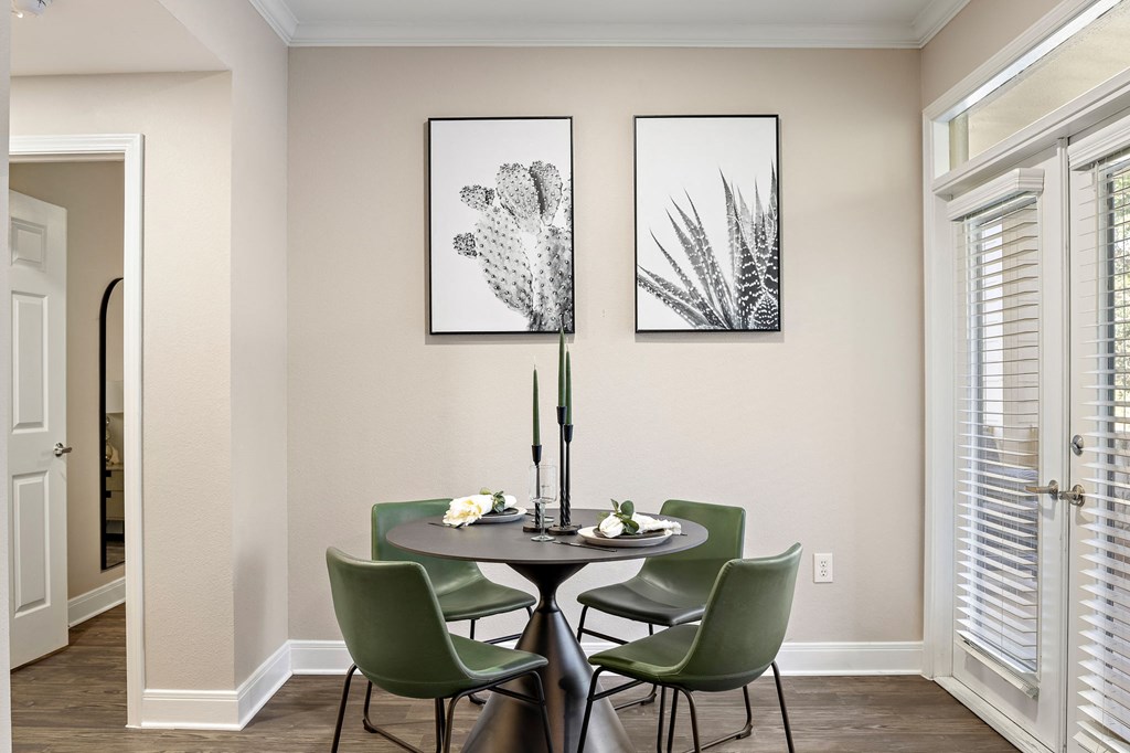 a dining room with a table and chairs and two pictures on the wall at The Verandah, Austin, Texas