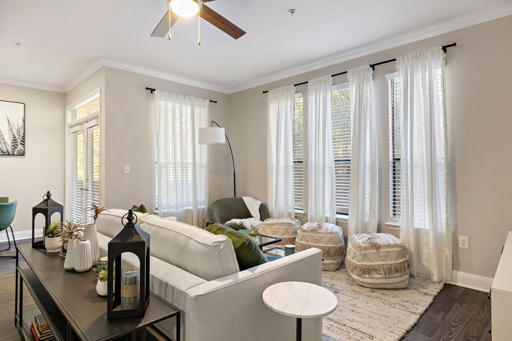 a living room with white curtains and a white couch at The Verandah, Texas, 78726