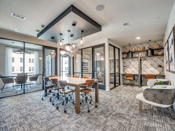 a conference room with a table and chairs and glass doors at Aurora Watson Branch, Mansfield, Texas