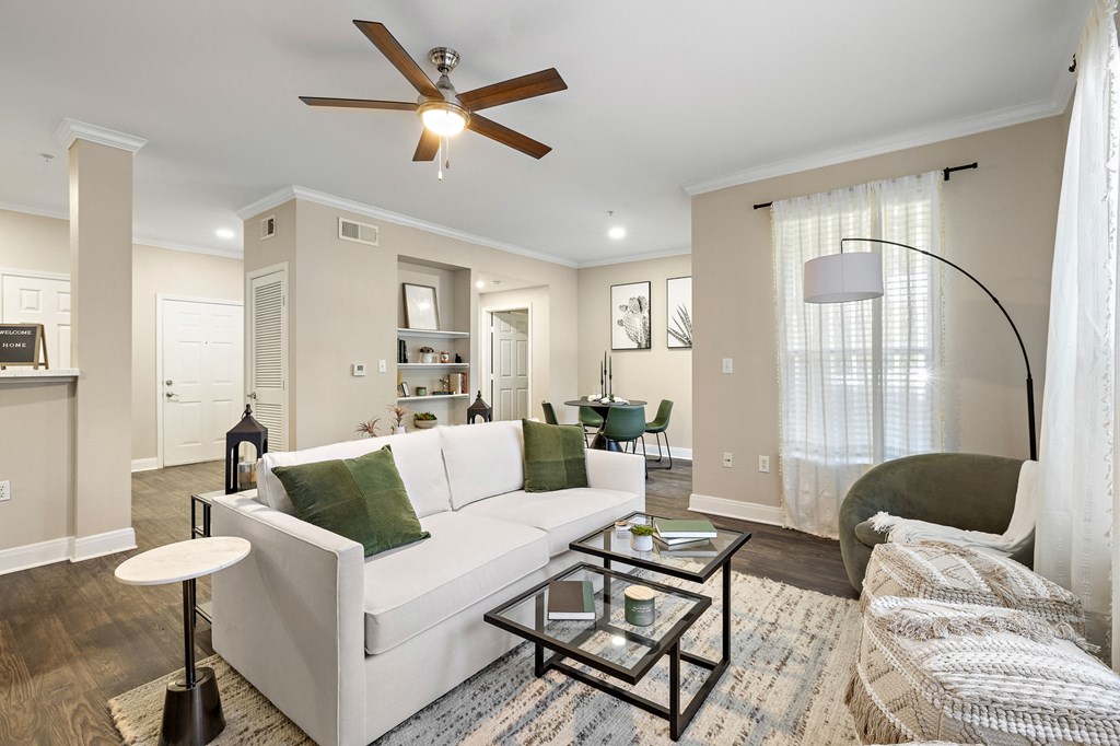 a living room with a white couch and a ceiling fan at The Verandah, Austin, Texas