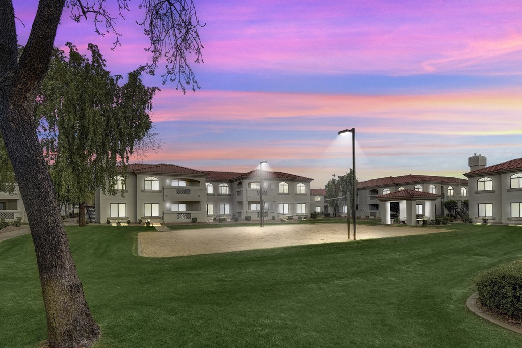 A large building with a lawn in front of it at San Montego Apartments, Arizona
