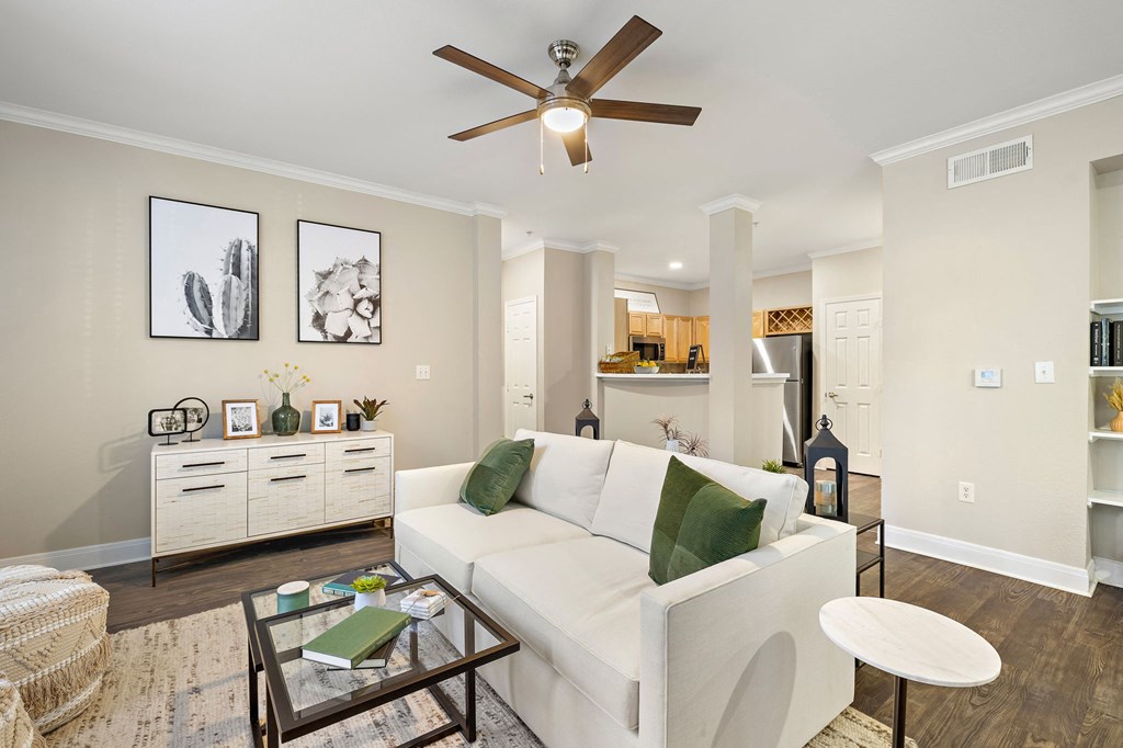 a living room with a white couch and a ceiling fan at The Verandah, Austin, 78726