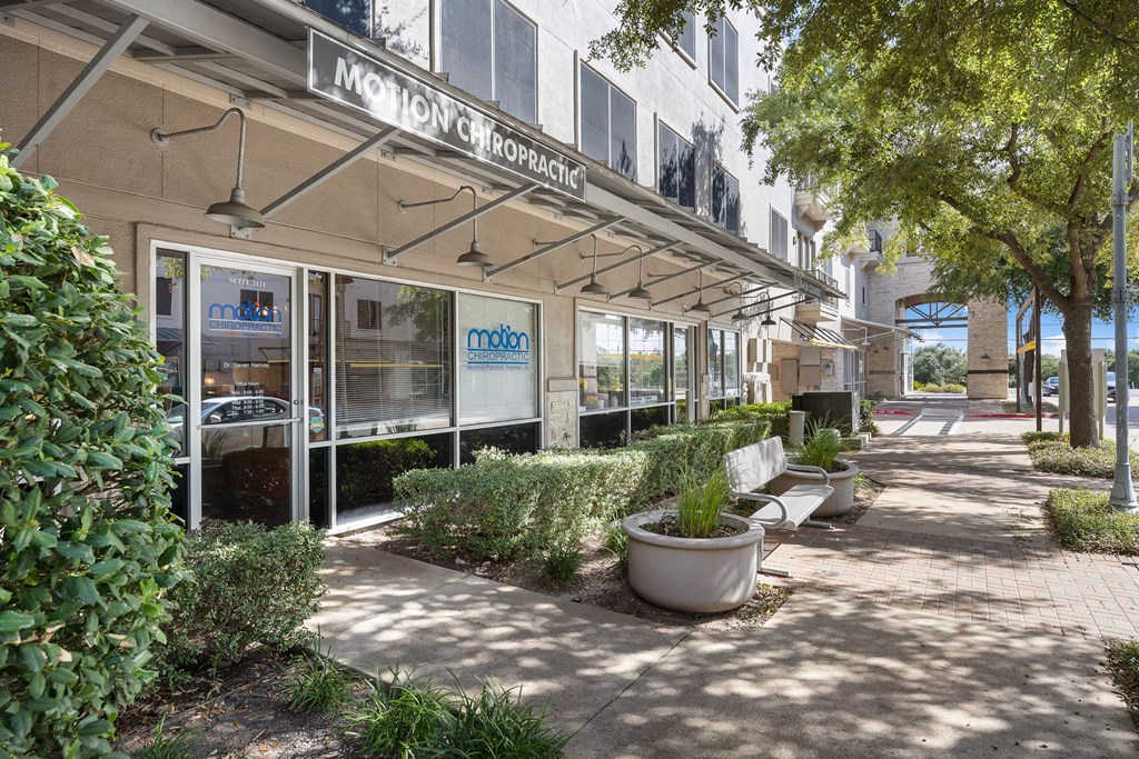 a building with a sign that reads monday on the front of it at Artisan Apartments & Shops, Austin, TX 78729