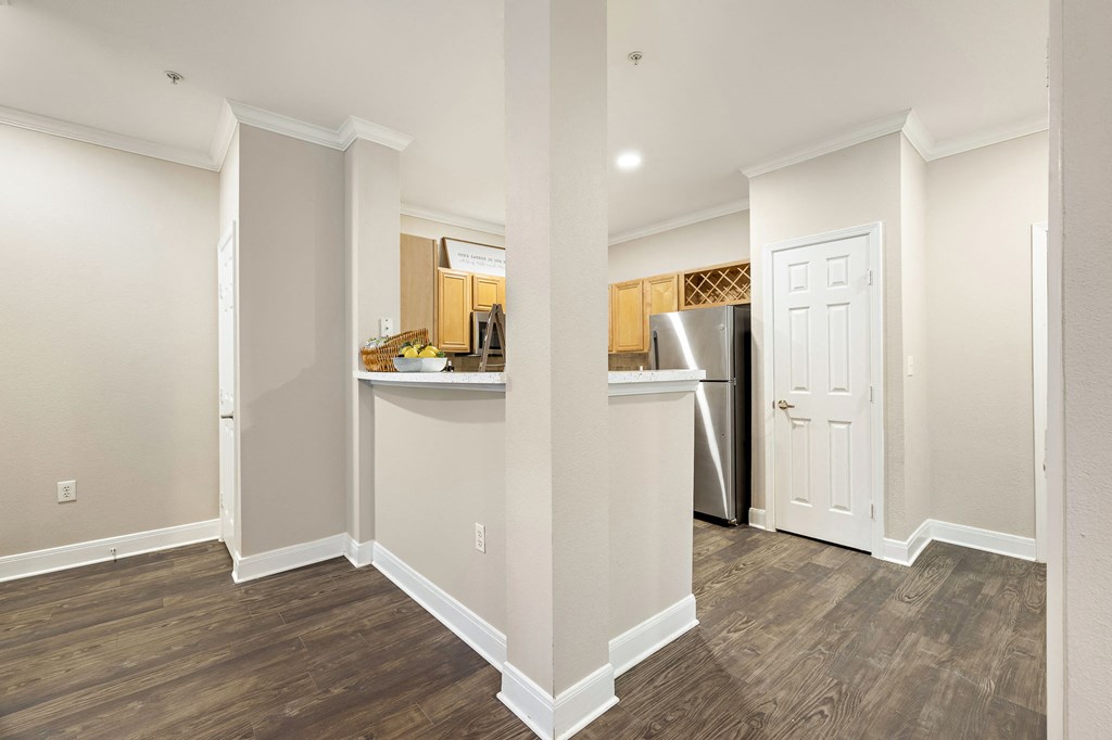 a renovated kitchen and living room with a refrigerator and a door at The Verandah, Texas, 78726
