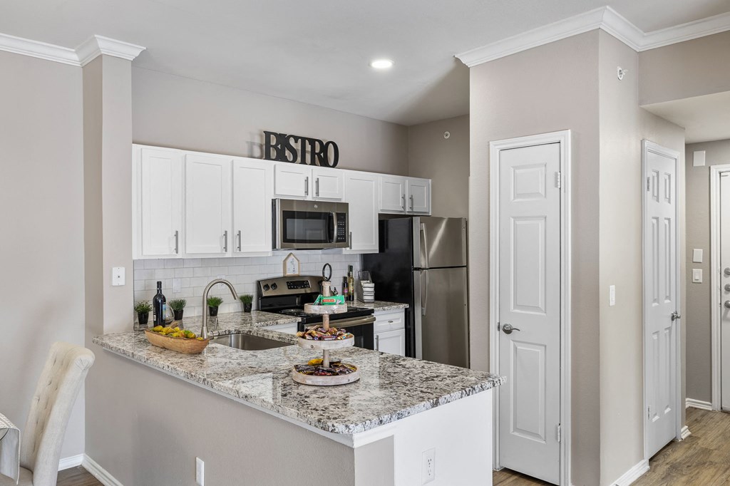 a kitchen with granite counter tops and stainless steel appliances at Sonterra Apartment Homes, Texas, 78726