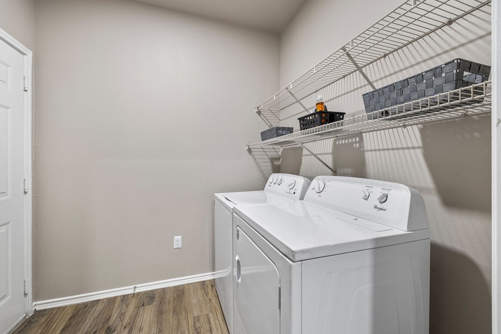 the laundry room of a home with a washer and dryer and a rack at Sonterra Apartment Homes, Austin, TX, 78726