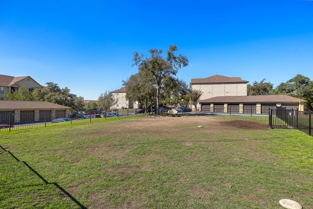 a large yard in front of a school with a building at The Verandah, Texas