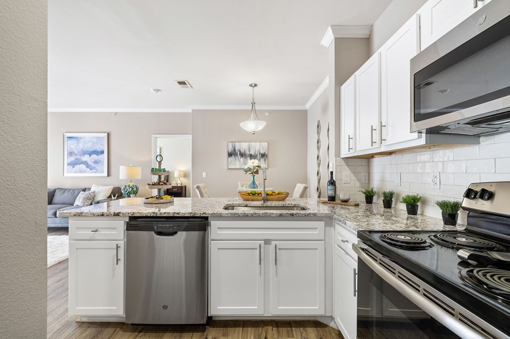 a kitchen with white cabinets and a counter top at Sonterra Apartment Homes, Austin, 78726