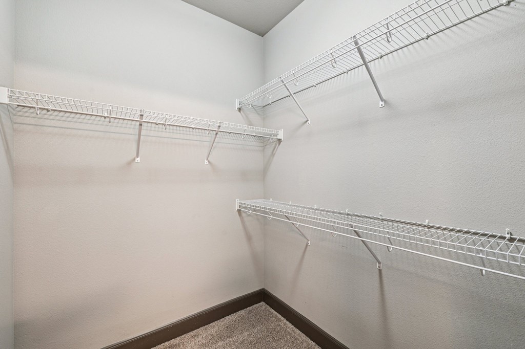 Empty white shelves in a room.