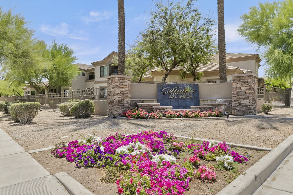 a garden with flowers and trees in front of a house  at Adiamo Palm Valley, Goodyear, AZ