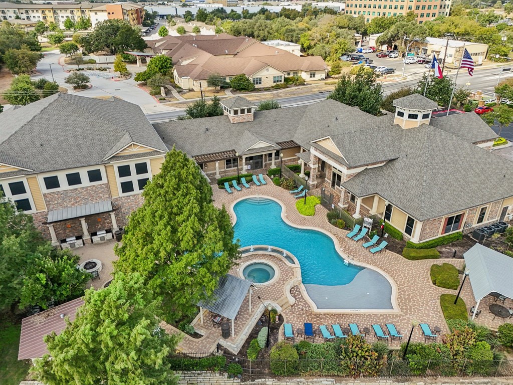 A large house with a pool in the middle of it.