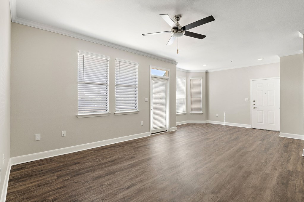 an empty living room with wood floors and a ceiling fan at The Verandah, Texas, 78726
