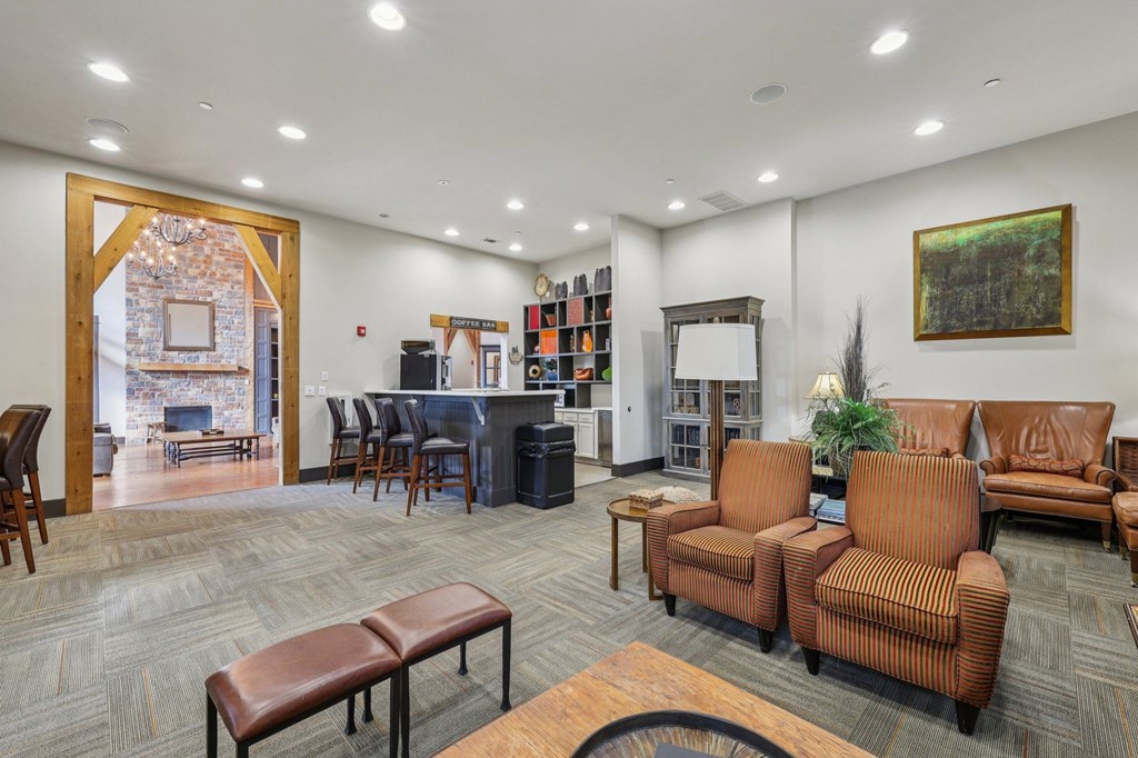 A living room with brown furniture and a painting on the wall.