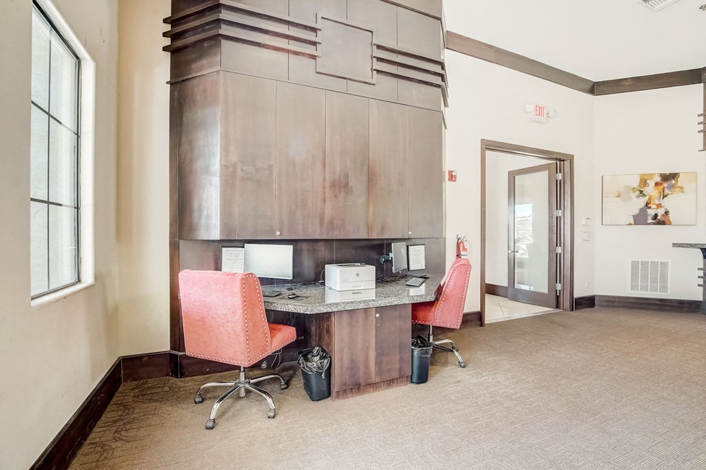 a conference room with two chairs and a desk with a microwave  at Adiamo Palm Valley, Goodyear, Arizona