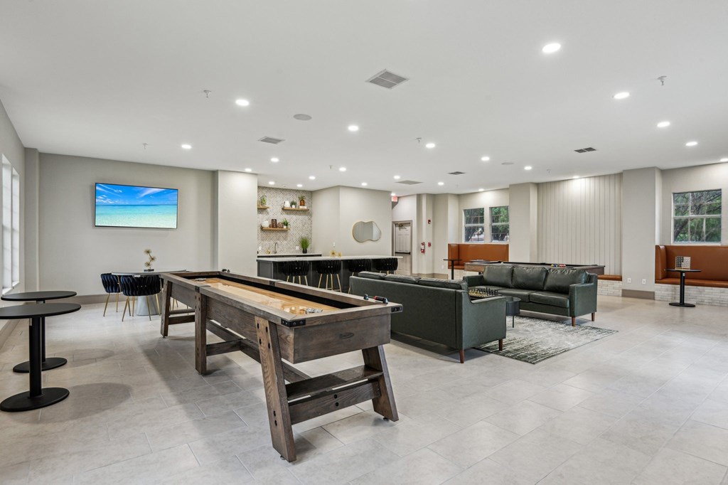 A room with a pool table and a couch.