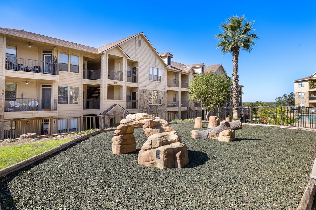 a playground in front of an apartment building at The Verandah, Austin, Texas