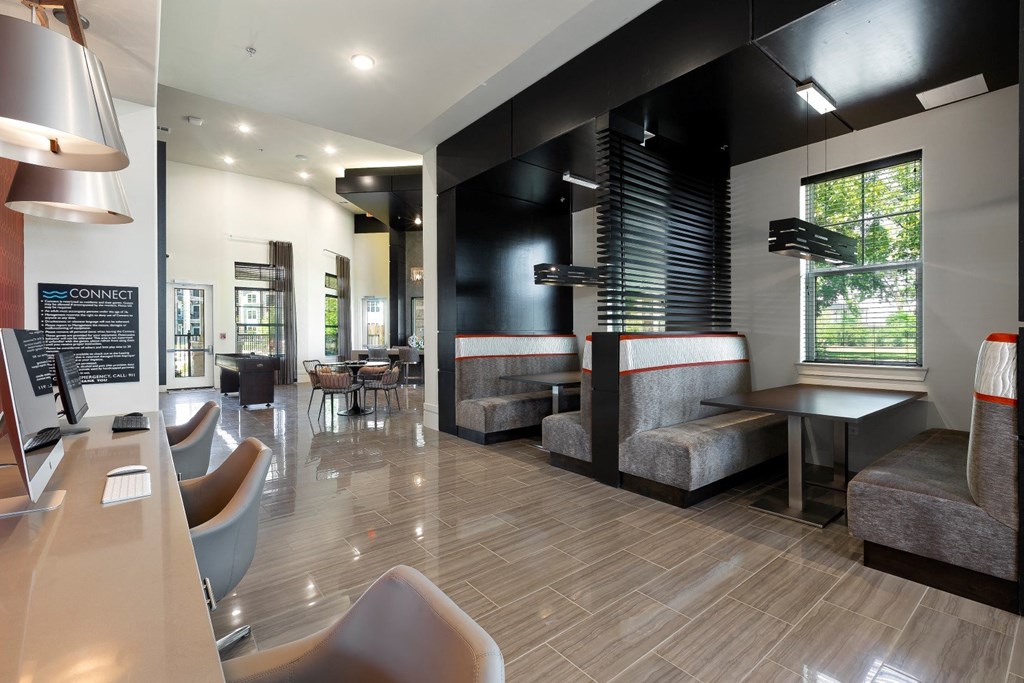a seating area with tables and chairs at a restaurant at North Creek, Hutto