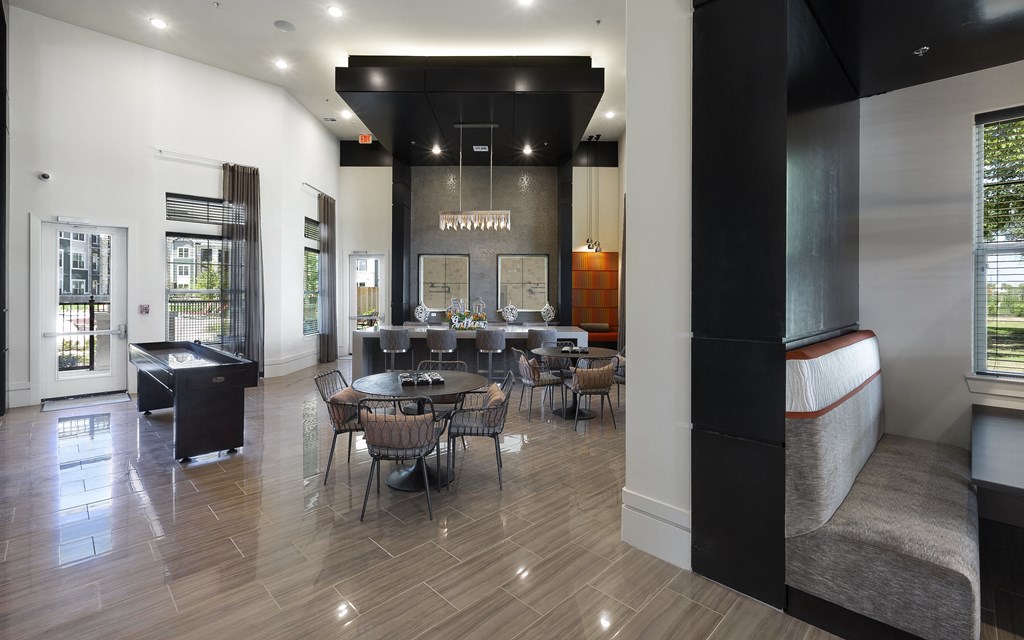 a dining room with tables and chairs and a bar in the corner at North Creek, Hutto, Texas