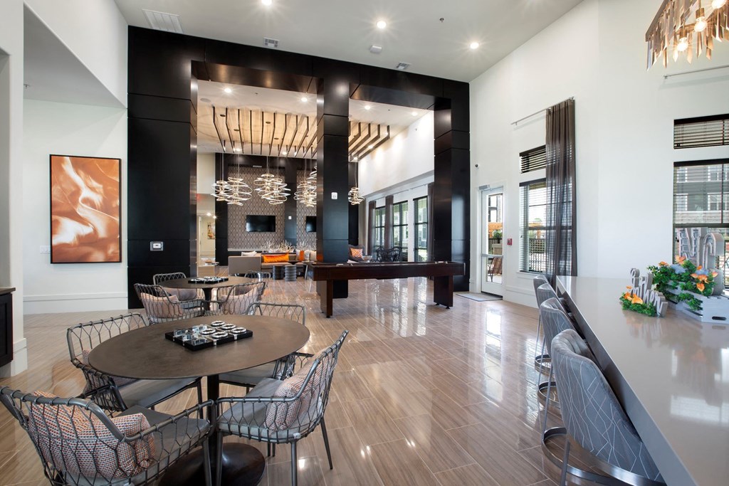a dining room with a table and chairs and a piano at North Creek, Hutto, TX