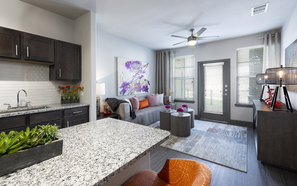 an open living room and kitchen with a granite counter top at North Creek, Texas, 78634