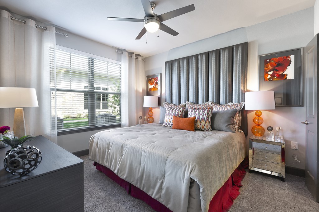a bedroom with a large bed and a ceiling fan at North Creek, Texas