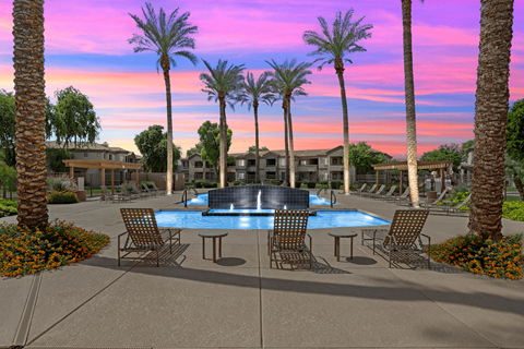 Pool fountain with trees at sunset 1 at Adiamo Palm Valley Apartments, Goodyear