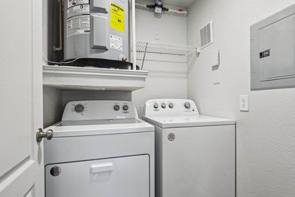A white washing machine and dryer in a small laundry room.