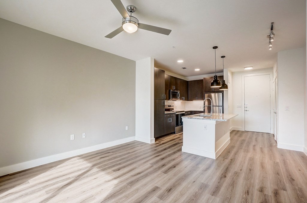 an empty living room and kitchen with a ceiling fan at Aurora Watson Branch, Mansfield, TX
