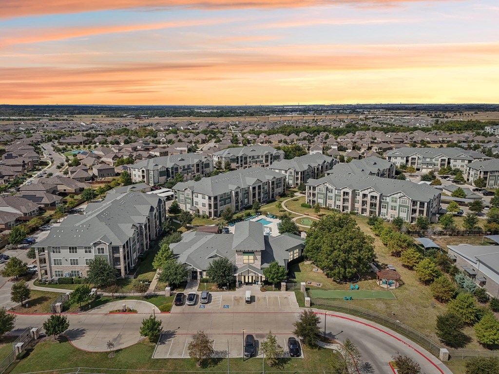 A large apartment complex with a playground in the foreground.