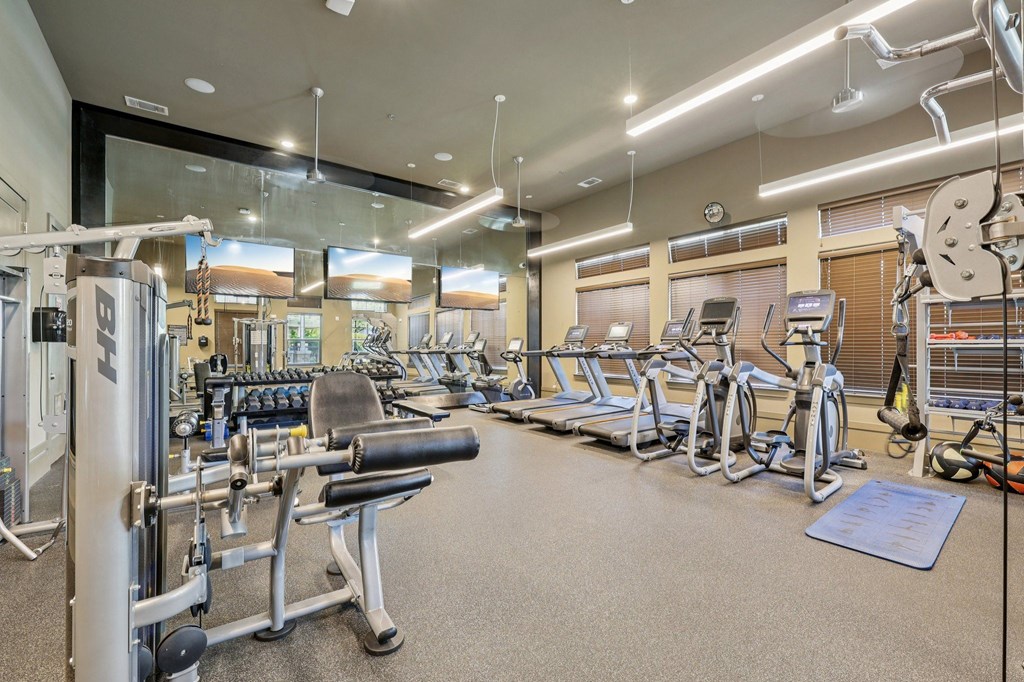 A well-equipped gym with a variety of machines and weightlifting equipment.