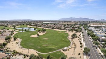 an aerial view of a golf course with a city in the background  at Adiamo Palm Valley, Arizona
